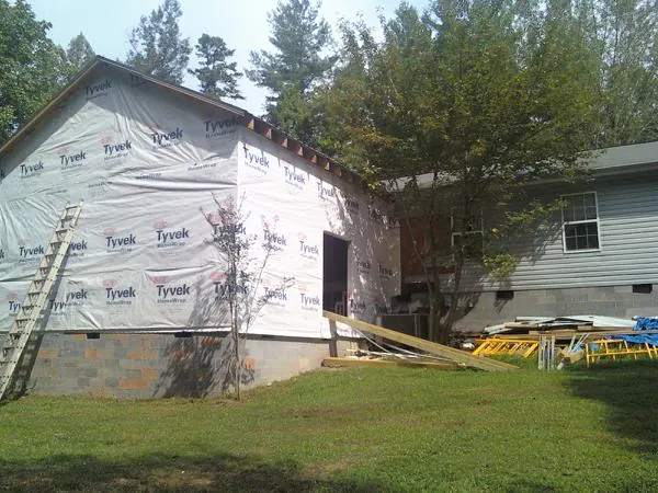 Tyvek wrapped gable on a new room addition beside an existing home in Lyman