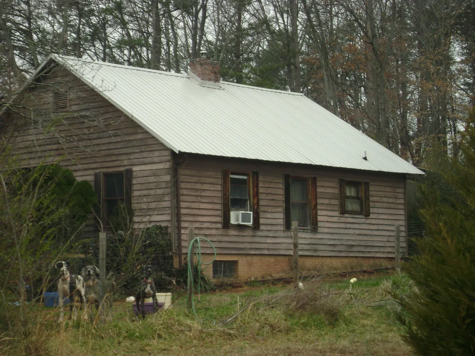 White metal roof on an old wood sided farmhouse, from a Metal Roof Installation job in Lyman